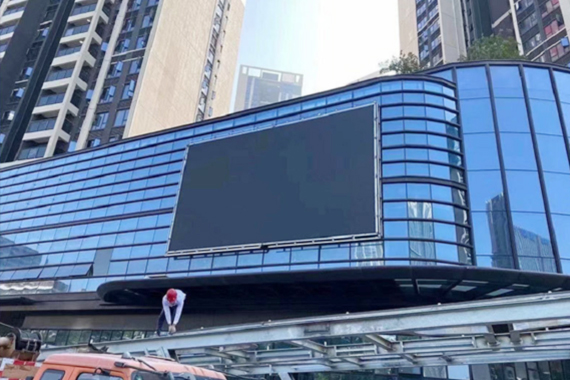 p6 outdoor led display screen in a commercial complex in singapore is being covered and waterproofed